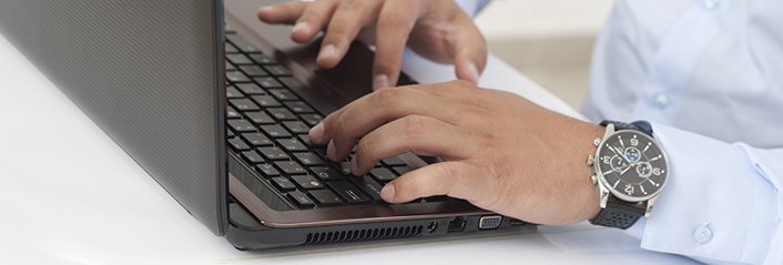 A man inquires about a service using his computer.